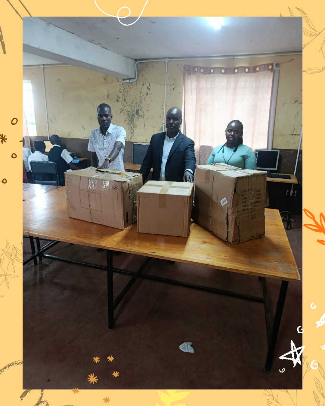 S4V Project Manager Leah and Gitothua Secondary School admins standing in front of donated computers in boxes.